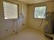 Utility room with cinderblock walls, water heater, and windows at 318 S Massachusetts Ave, Deland, FL 32724