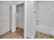 Bathroom with open closet area, a vanity, and a shower-tub combo at 321 Wade Ave, Deland, FL 32724