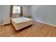 Bedroom featuring hardwood floors, neutral walls, and furniture including a bed and dressers at 321 Wade Ave, Deland, FL 32724