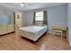 Bedroom featuring hardwood floors, neutral walls, and furniture including a bed and dressers at 321 Wade Ave, Deland, FL 32724