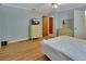 Bedroom featuring hardwood floors, neutral walls, and furniture including dressers and a television at 321 Wade Ave, Deland, FL 32724