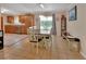 Bright dining area featuring modern lighting, tile floors, and backyard access at 321 Wade Ave, Deland, FL 32724