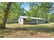 Angle view of well-kept home with a spacious yard and a partial fence surround at 321 Wade Ave, Deland, FL 32724