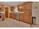 Traditional kitchen featuring oak cabinets, stainless steel appliances, and neutral tile floors at 321 Wade Ave, Deland, FL 32724