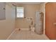 Laundry room with tile floors, a water heater, washer hookups and wire shelving at 321 Wade Ave, Deland, FL 32724