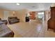 Spacious living room with tile floors flowing into the dining area and kitchen at 321 Wade Ave, Deland, FL 32724