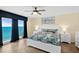 Bright bedroom with a balcony offering ocean views, tile floors, and coastal-themed decor at 3333 S Atlantic Ave # 2202, Daytona Beach, FL 32118