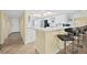 Modern kitchen with breakfast bar, stainless appliances, and tile flooring at 3333 S Atlantic Ave # 2202, Daytona Beach, FL 32118