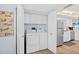Convenient in-unit laundry featuring a washer, dryer, and additional storage cabinets, adjacent to the kitchen at 3333 S Atlantic Ave # 2202, Daytona Beach, FL 32118