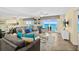 Cozy living room with comfortable seating, tile flooring, and panoramic ocean views from the balcony at 3333 S Atlantic Ave # 2202, Daytona Beach, FL 32118