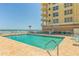 Exterior swimming pool with lounge chairs near the beach and a high-rise building at 3333 S Atlantic Ave # 2202, Daytona Beach, FL 32118