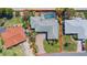 Aerial view of a single-story house with a pool, brick driveway, and lush landscaping at 36 Sand Dollar Dr, Ormond Beach, FL 32176