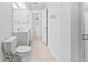 Bright bathroom featuring dual sinks, a toilet, and a walk-in shower at 36 Sand Dollar Dr, Ormond Beach, FL 32176
