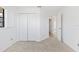 Carpeted bedroom featuring a large closet and an open doorway to the rest of the house at 36 Sand Dollar Dr, Ormond Beach, FL 32176