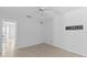 Neutral bedroom with white walls, tile floor, ceiling fan and a wall mount at 36 Sand Dollar Dr, Ormond Beach, FL 32176