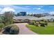 Beautiful single-story brick home with manicured landscaping, lush greenery, and a brick driveway at 36 Sand Dollar Dr, Ormond Beach, FL 32176