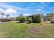 Well manicured lawn featuring green grass, mature shrubs and large brick paved drive at 36 Sand Dollar Dr, Ormond Beach, FL 32176