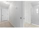 Hallway leading to bathroom featuring updated shower and tile floors at 36 Sand Dollar Dr, Ormond Beach, FL 32176