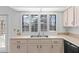 Bright kitchen with white shutters, tile countertops, and stainless steel sink at 36 Sand Dollar Dr, Ormond Beach, FL 32176