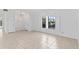 Bright and airy living area featuring tile floors, natural light, and a view of the outdoors at 36 Sand Dollar Dr, Ormond Beach, FL 32176