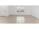 Bright living room with tile flooring and plenty of natural light from the large window at 36 Sand Dollar Dr, Ormond Beach, FL 32176