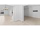 Open-concept living room with tile floors, a chandelier, and white walls at 36 Sand Dollar Dr, Ormond Beach, FL 32176
