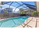 Enclosed pool area with clear blue water, stainless steel rails, and a screened enclosure at 36 Sand Dollar Dr, Ormond Beach, FL 32176