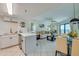 Comfortable living room adjacent to a white kitchen, showcasing an open floor plan at 3647 S Atlantic Ave # 5B, Daytona Beach, FL 32118