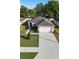 Aerial view of a single-Gathering home with a two-car garage, driveway, and landscaping at 3825 Arborvitae Way, Deland, FL 32724