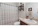 Cozy bathroom featuring a vanity, toilet, and shower with stylish decor and ample storage at 3825 Arborvitae Way, Deland, FL 32724