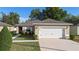 Charming single-Gathering home featuring a two-car garage, well-maintained lawn, and neutral exterior at 3825 Arborvitae Way, Deland, FL 32724