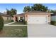Charming home with a well-manicured lawn and a two-car garage at 3825 Arborvitae Way, Deland, FL 32724