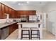 Charming kitchen with stainless steel appliances, granite countertops, and a cozy breakfast bar with stools at 3825 Arborvitae Way, Deland, FL 32724