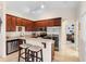 Well-lit kitchen with stainless steel appliances and a breakfast bar adjacent to the living area at 3825 Arborvitae Way, Deland, FL 32724