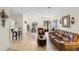 Spacious living room with tile flooring, a cozy sofa, and a breakfast bar at 3825 Arborvitae Way, Deland, FL 32724