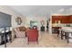 Open concept living room with tile floors seamlessly connecting the kitchen and seating areas at 3825 Arborvitae Way, Deland, FL 32724