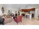 Open-concept living space with a kitchen, living room, and view of a bedroom at 3825 Arborvitae Way, Deland, FL 32724