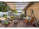 Relaxing outdoor patio with a covered pergola, wicker furniture, and a swing at 3825 Arborvitae Way, Deland, FL 32724