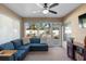 Bright sunroom with large windows and comfortable seating. Patio and backyard can be seen in the distance at 3825 Arborvitae Way, Deland, FL 32724