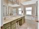 A bathroom featuring double sinks, garden tub, large mirror and olive cabinets at 47 Spring Glen Dr, Debary, FL 32713