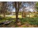 The backyard leads down to a lake, with mature trees and foliage, with an old boat at 50 Lake Dr # 1/2, Debary, FL 32713