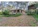 Back exterior with wooden deck and ample foliage at 50 Lake Dr # 1/2, Debary, FL 32713