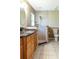 Bathroom features a tiled shower, granite countertop, and tiled floors at 50 Lake Dr # 1/2, Debary, FL 32713