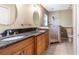 Bathroom with granite countertop vanity, double sinks, and tiled walk-in shower at 50 Lake Dr # 1/2, Debary, FL 32713