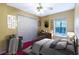 Bedroom offers lots of closet space, a ceiling fan, and a large window with natural light at 50 Lake Dr # 1/2, Debary, FL 32713