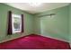 Bedroom features a large window, purple curtains, and carpeted floors at 50 Lake Dr # 1/2, Debary, FL 32713