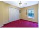 Bedroom offers closet space, a ceiling fan, and a large window at 50 Lake Dr # 1/2, Debary, FL 32713