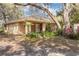 Welcoming brick home featuring a covered front porch and lush landscaping at 50 Lake Dr # 1/2, Debary, FL 32713