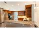 Open kitchen with granite countertops, stainless steel appliances, and wood cabinets at 50 Lake Dr # 1/2, Debary, FL 32713