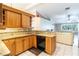 Updated kitchen features granite countertops, tile backsplash, and custom wood cabinets at 50 Lake Dr # 1/2, Debary, FL 32713